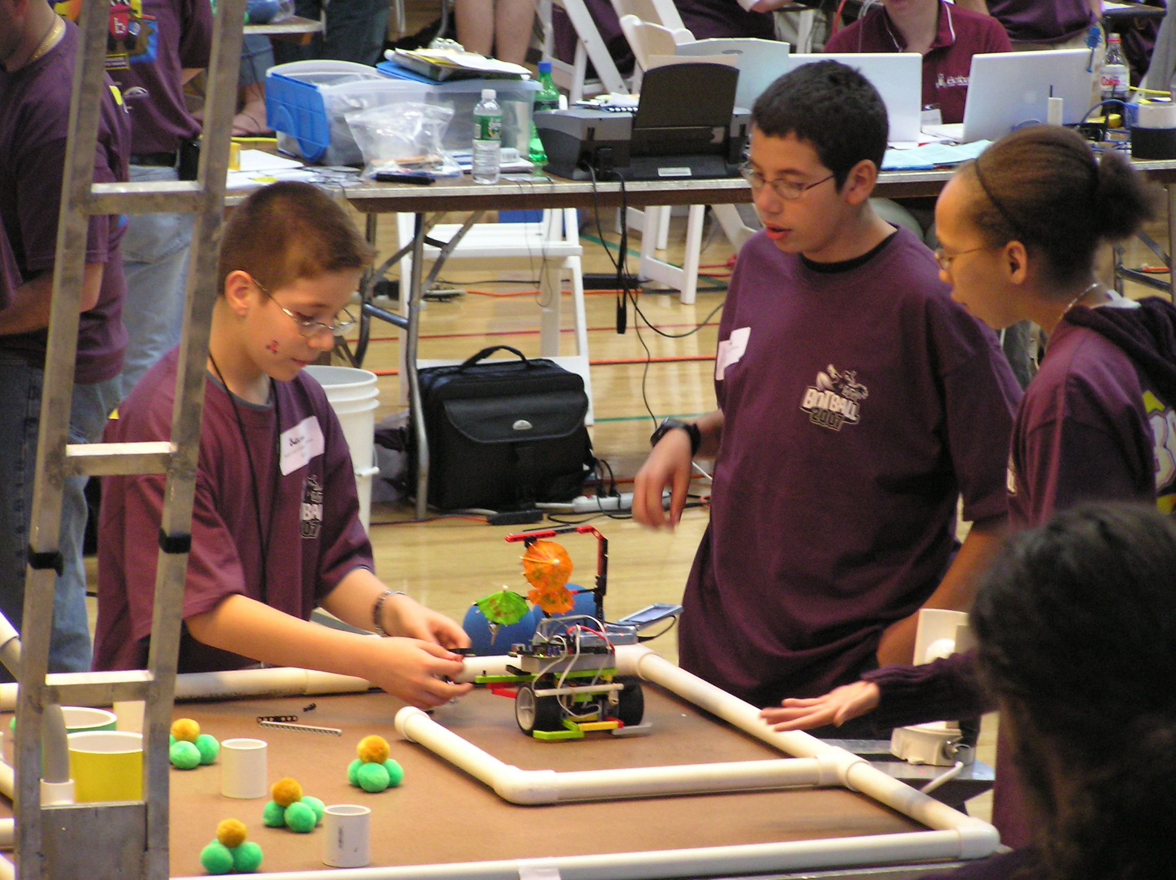 The James Lee Team watches their bot as they set it off on the botball rink